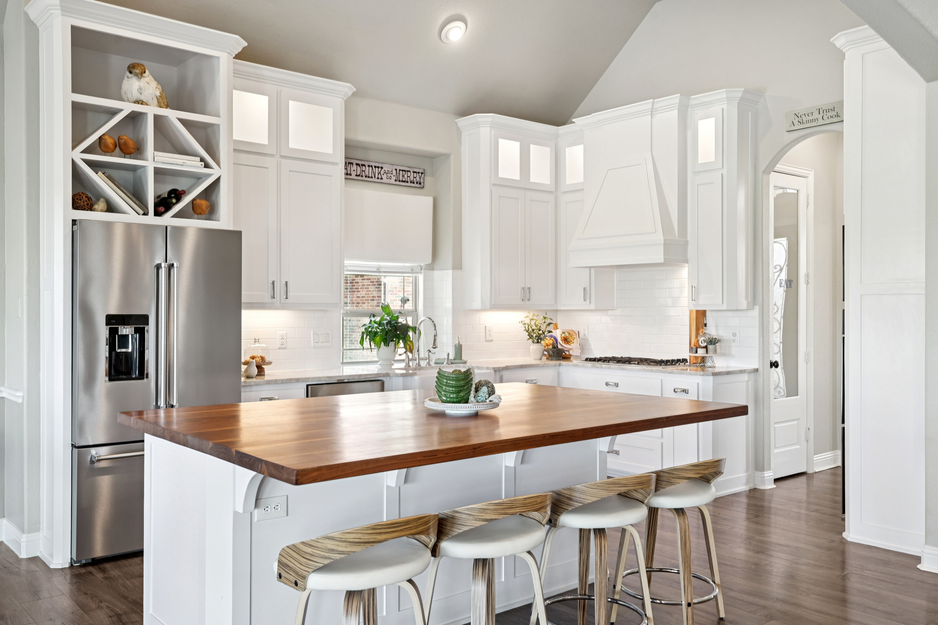 Beautifully staged Colleyville-area kitchen with white cabinetry and butcher block island